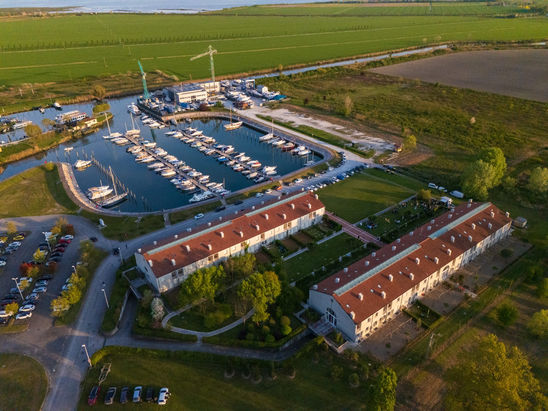 Aerial view of H-FARM Marina, a renovated dock in the Venetian lagoon with boats and student apartments